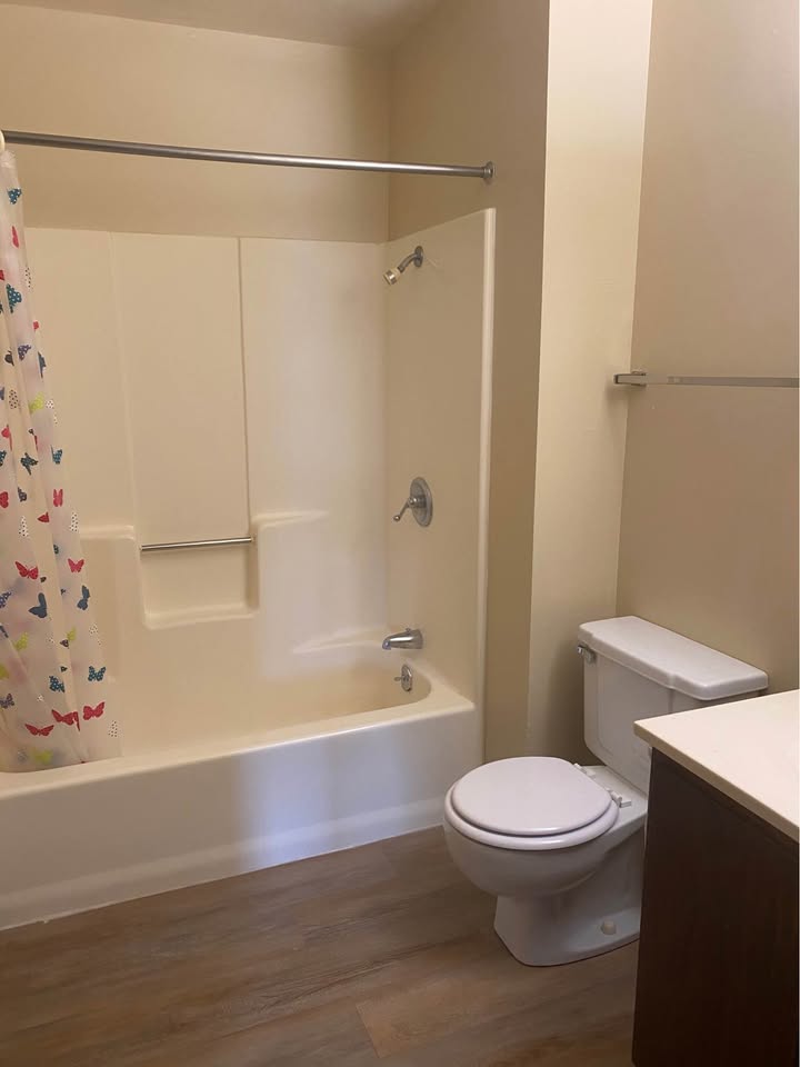 Full bathroom with tub and shower, toilet and vanity